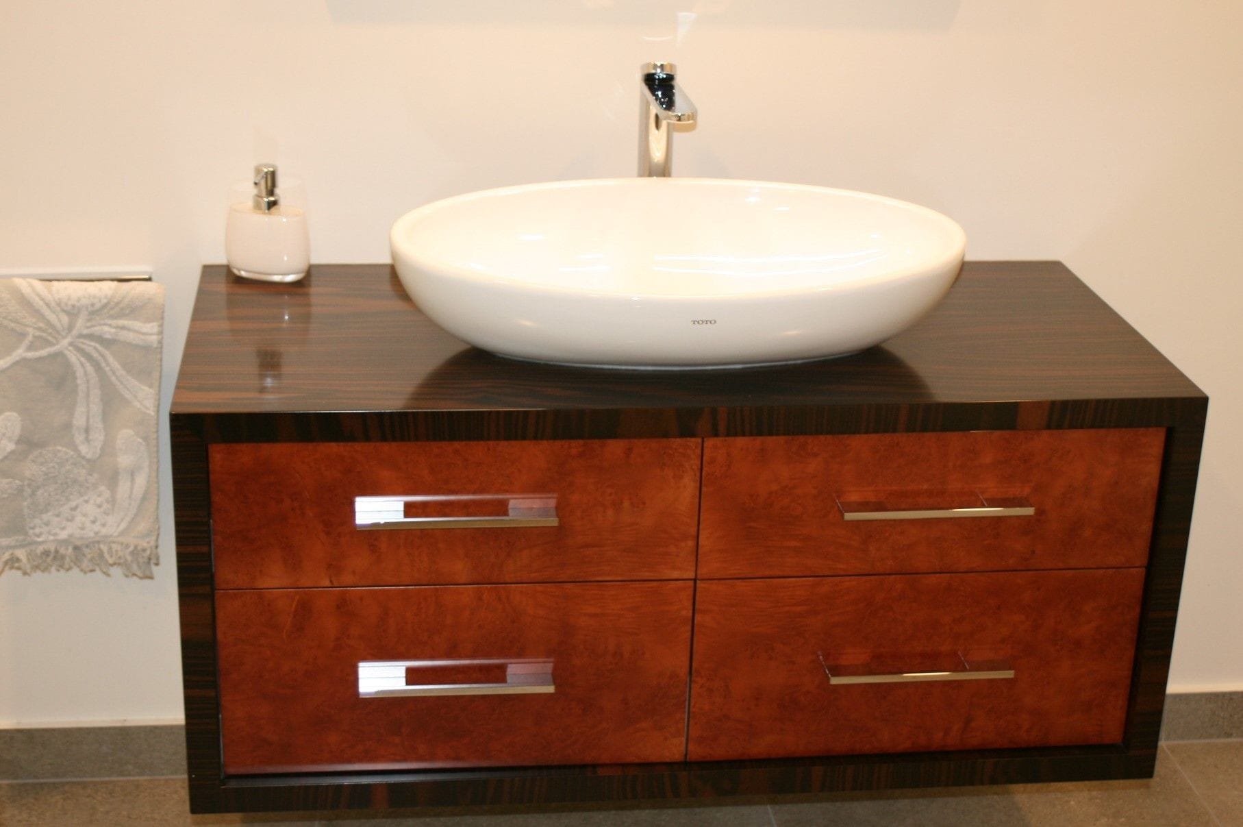 Macasa Ebony Vanity with Maple Burr drawer fronts. Wall mounted so vanity floats free from the floor. Toto basin and mixer.